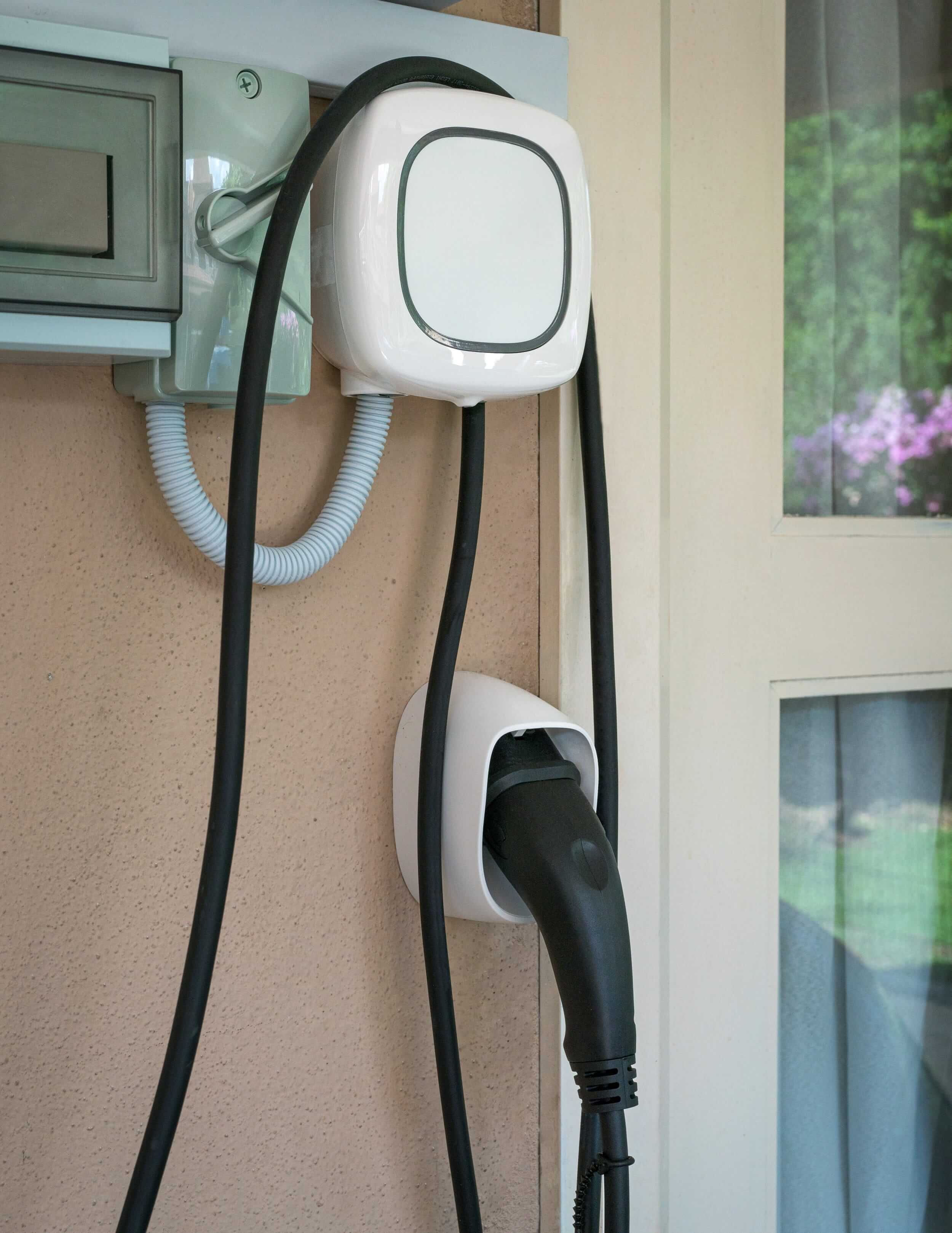 Wall-mounted EV charger installed on the exterior of a residential property.